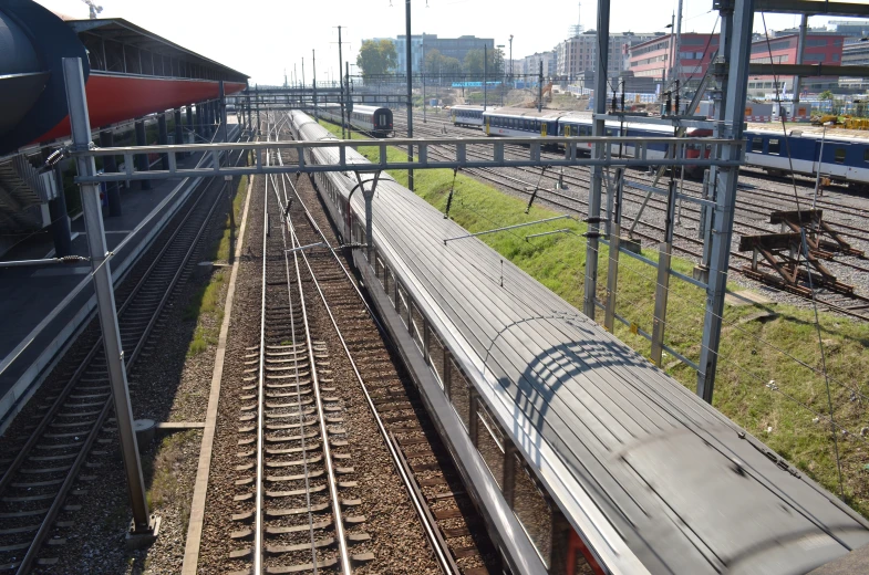 trains on parallel train tracks with their platforms at the end