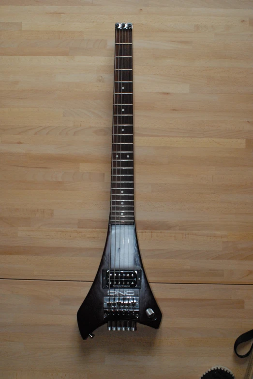 a black guitar with some music accessories around it
