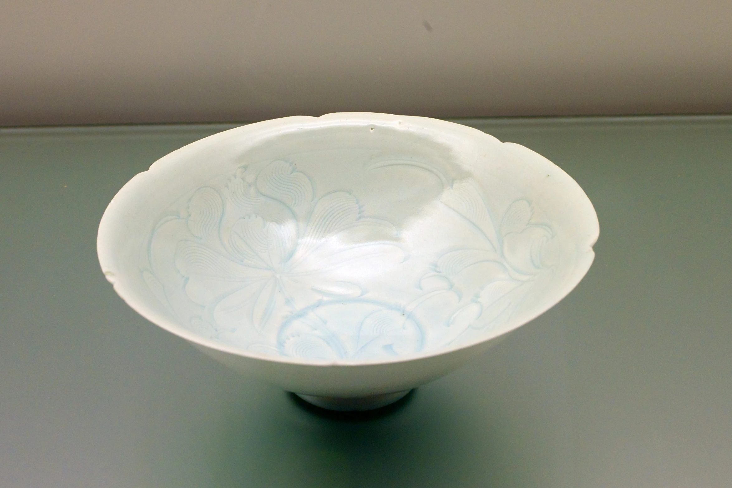 an empty bowl with designs is sitting on a table