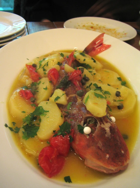 a white plate topped with food next to another plate