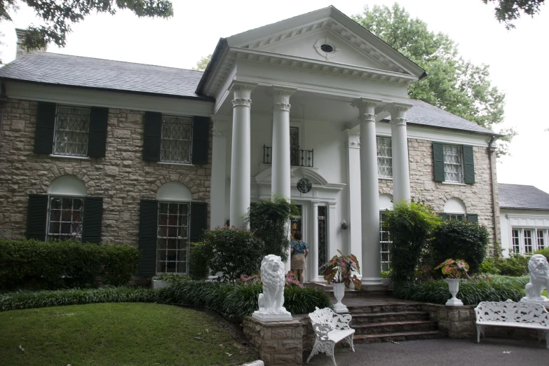 a large house with many statues on front and windows