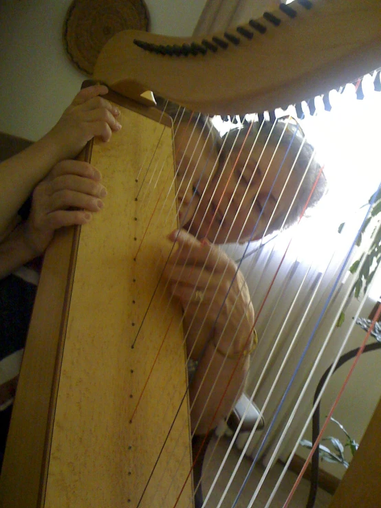 a man playing an instrument in front of some people