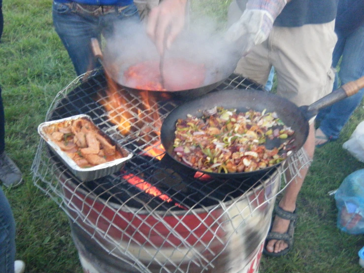 a large grill with food cooking on it