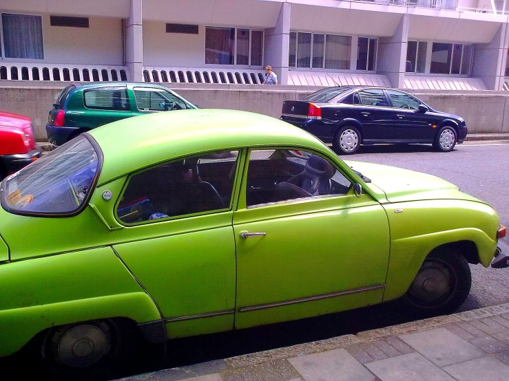 a lime green car parked on the side of a street