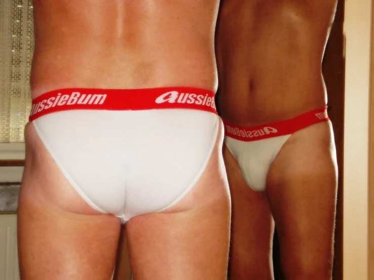 two underwear clad men with logo on them