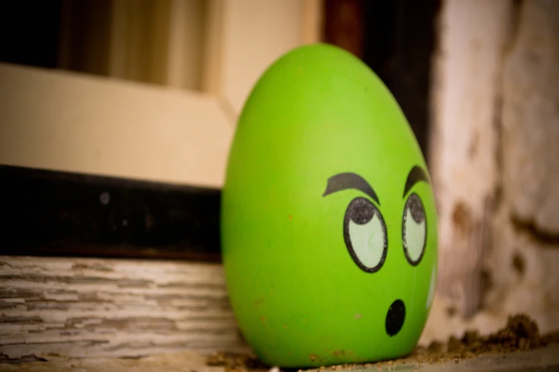 an egg with eyes on a window sill