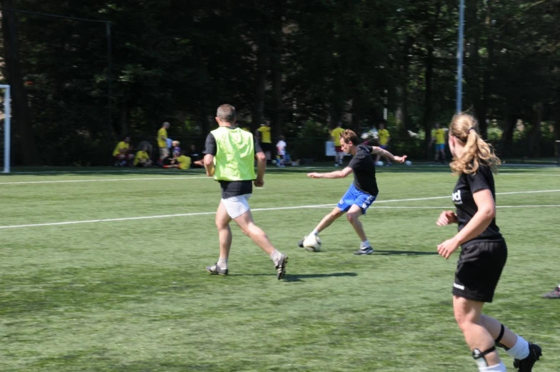 people in a field playing soccer with each other