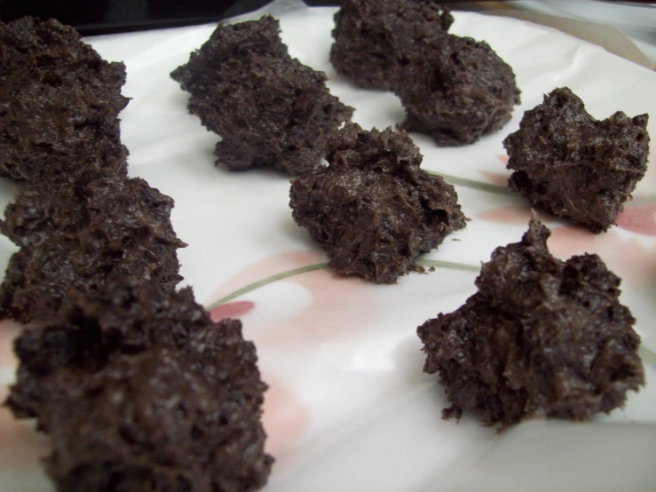 an assortment of chocolate cookies on paper on a white plate