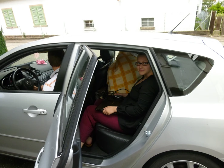 the women is driving her car alone in the sunshine