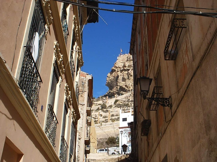 the narrow alley has a view of a cliff