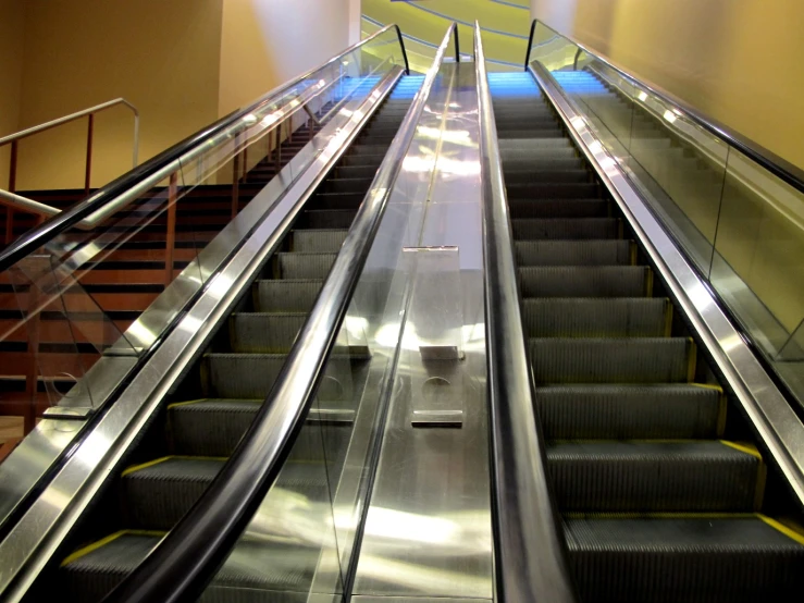 an escalator at the airport with several people on it