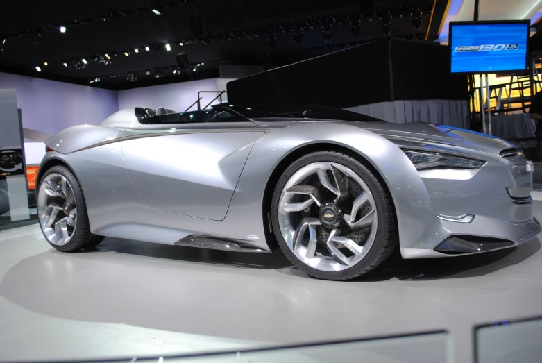 the silver sports car is on display at the show