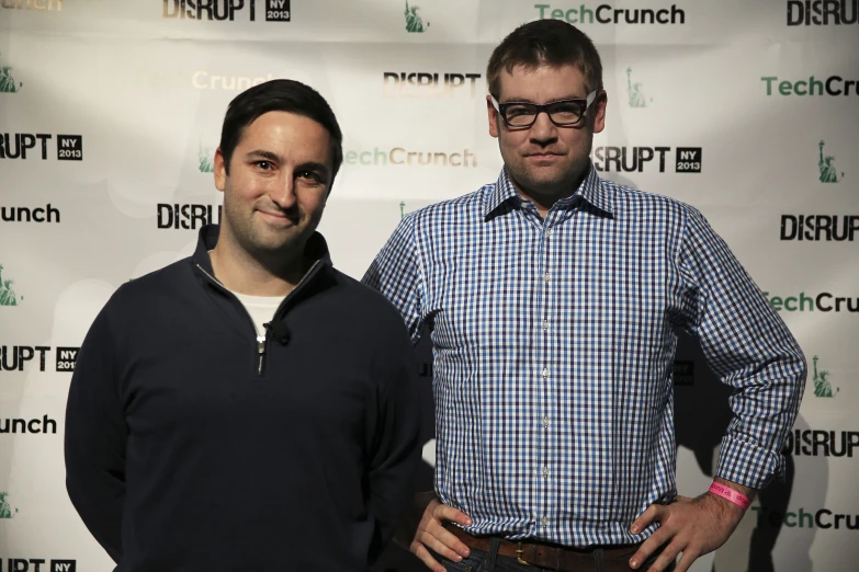 two men in plaid shirts posing for a po