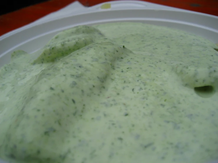 a white plate with some green substance in it