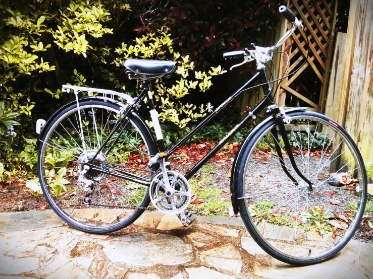 there is a bicycle parked on the stone sidewalk