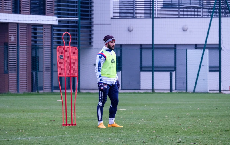 a man standing next to a soccer goal