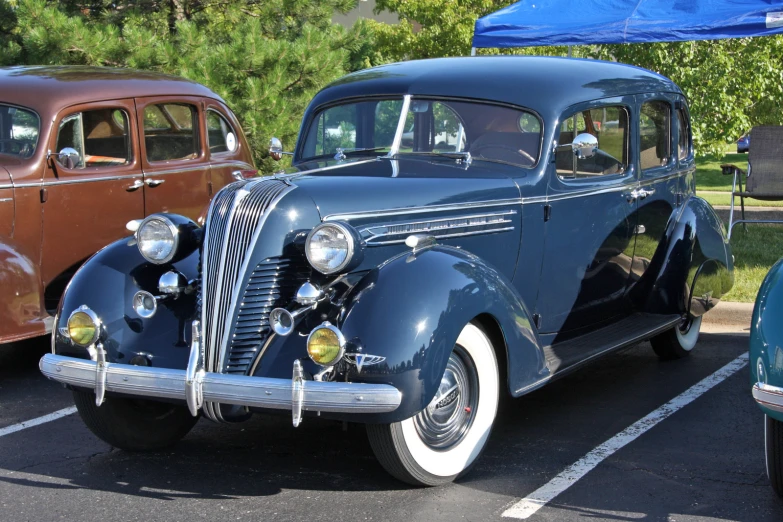 an old car is shown in a parking lot