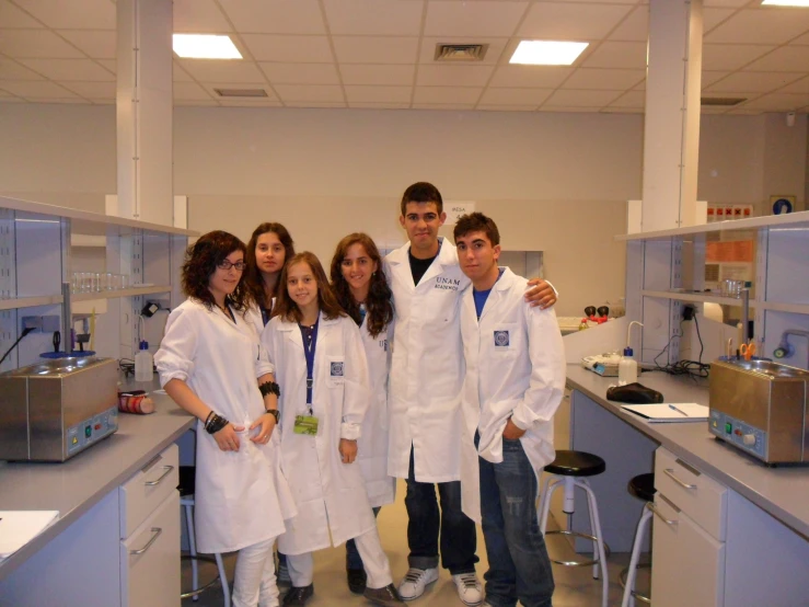 a group of young adults in lab coats standing together