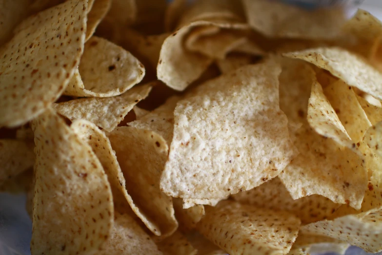 a pile of tortilla chips sitting on top of a plate