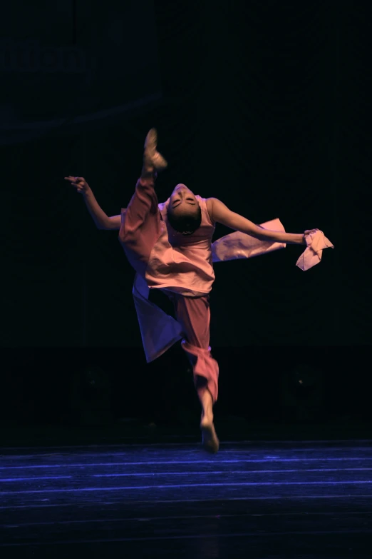 a person in white dancing on stage