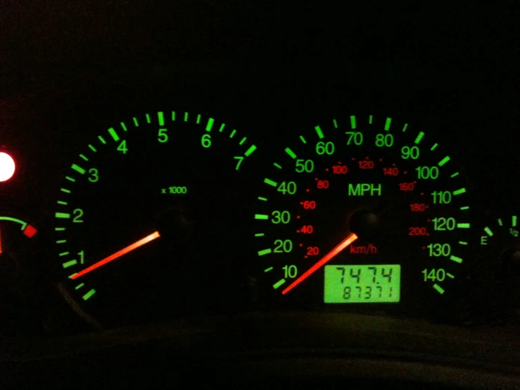 the dashboard of a car with glow on it