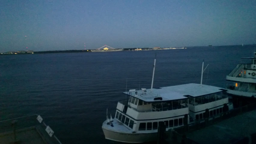 a boat parked at the dock in front of another boat