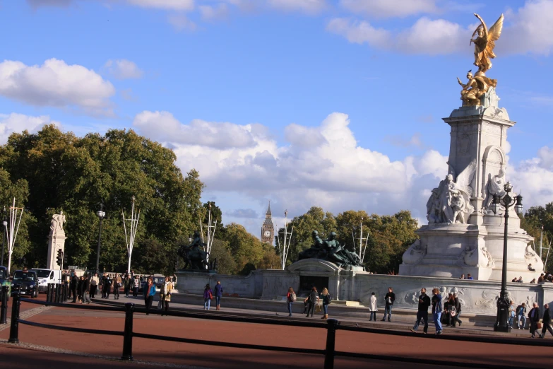 people on a walk way near a statue