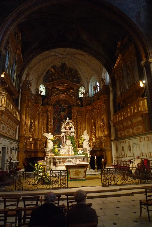 the interior of a church with benches and ornate sculptures