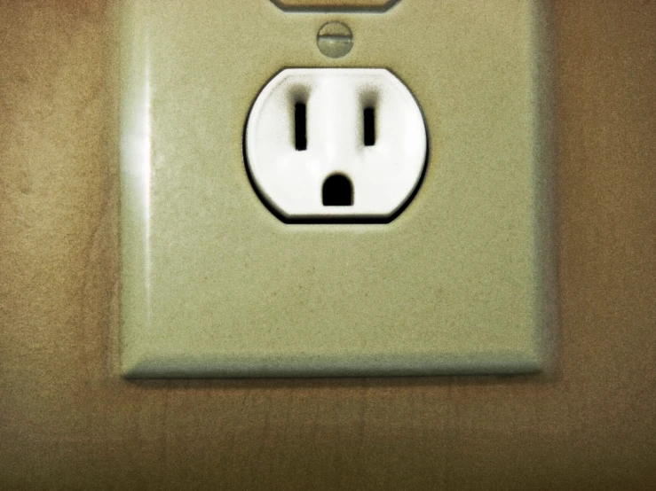 an electrical outlet is placed in the wall with brown accents