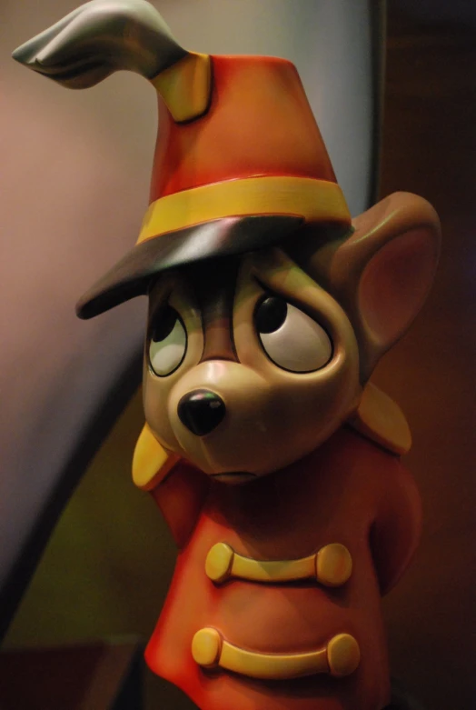 a toy with a fake hat and orange outfit