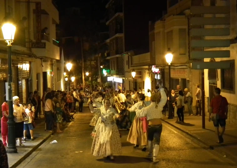 a crowded street with people dressed in costumes