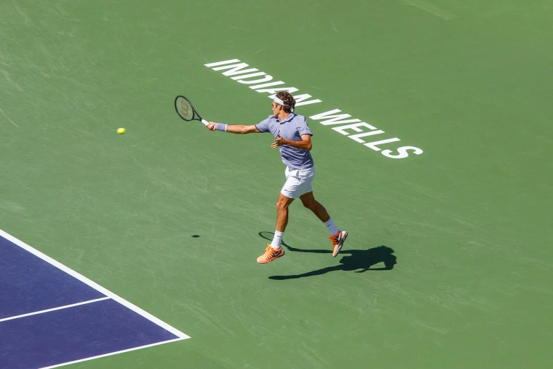 a tennis player runs to hit a tennis ball