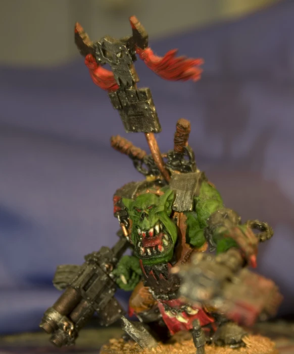 a zombie - like troll with a gun and sword