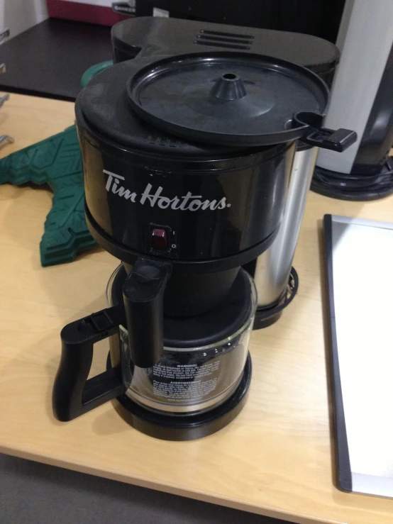 a small coffee maker on top of a table