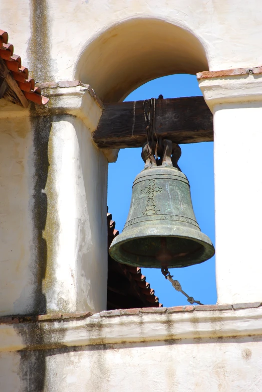 an old, rusty bell in the tower of a building