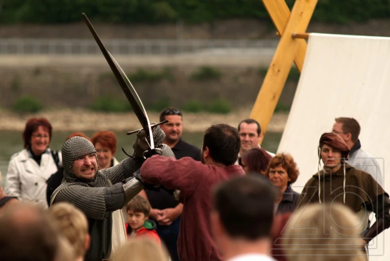 a group of people standing around each other and holding sword