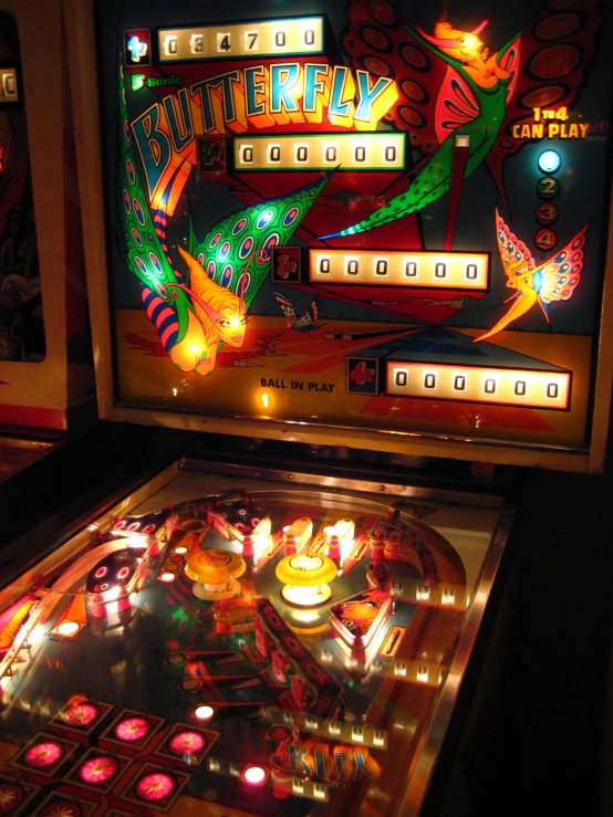 an old time pinball game that is lit up with neon lights