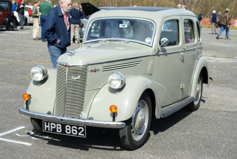 an older car is parked in a parking space