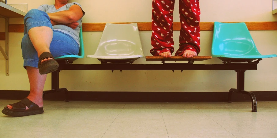 two people sitting on chairs in a room