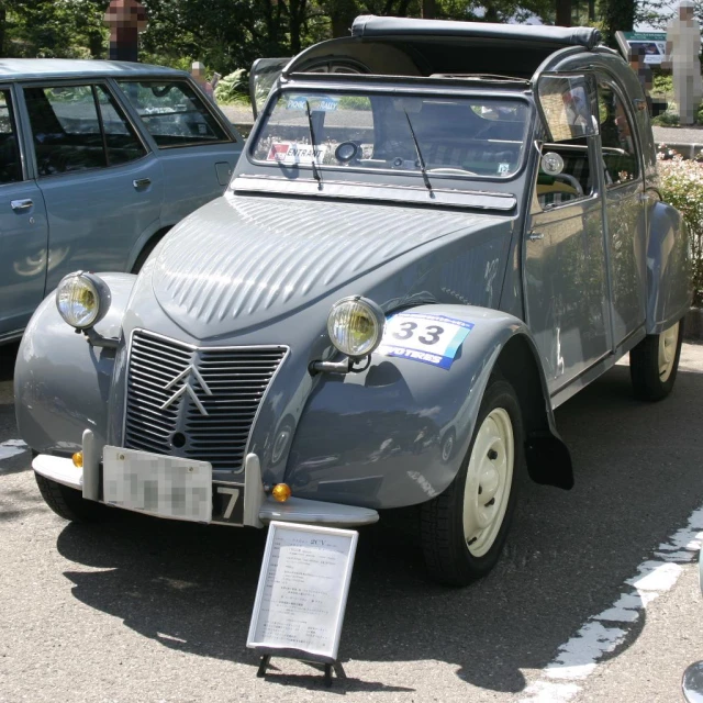 an old car parked on a parking lot near other cars