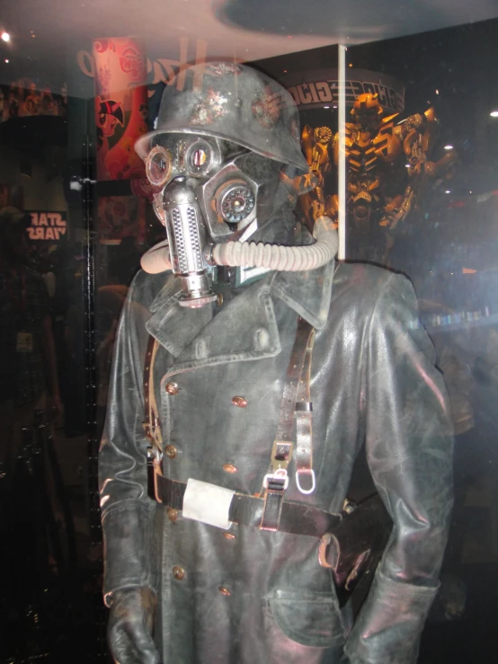 a leather suit with a gas mask and leather boots