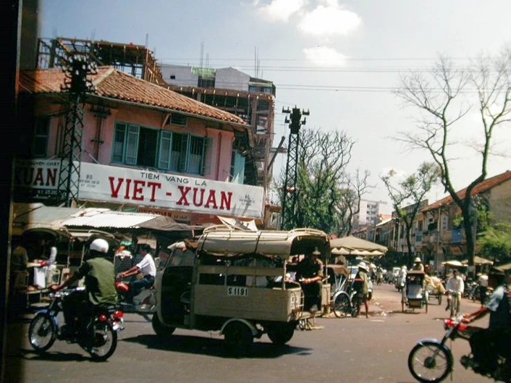 an old - time scene shows a street vendor in vietnam