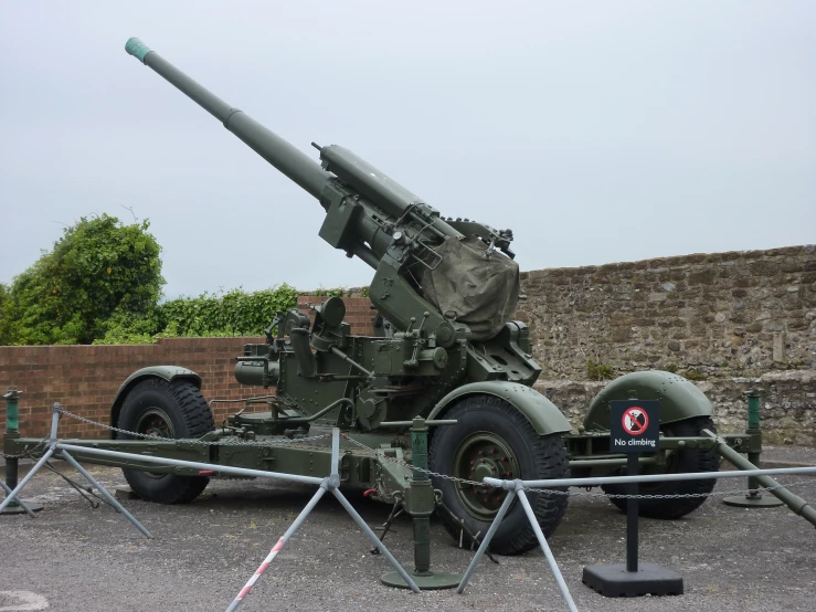 a large military rifle is sitting in the middle of the road