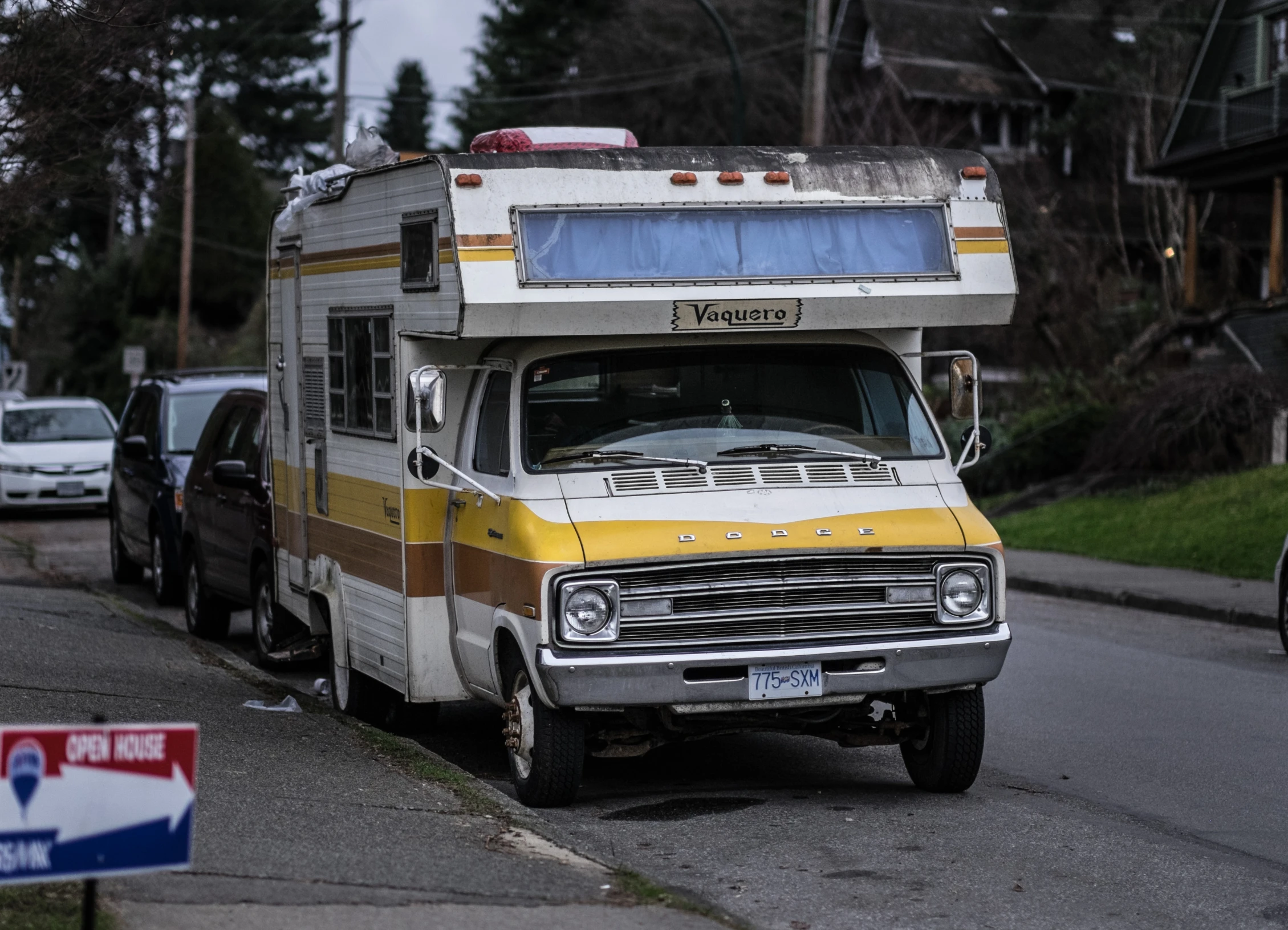 an old bus is parked on the side of the road