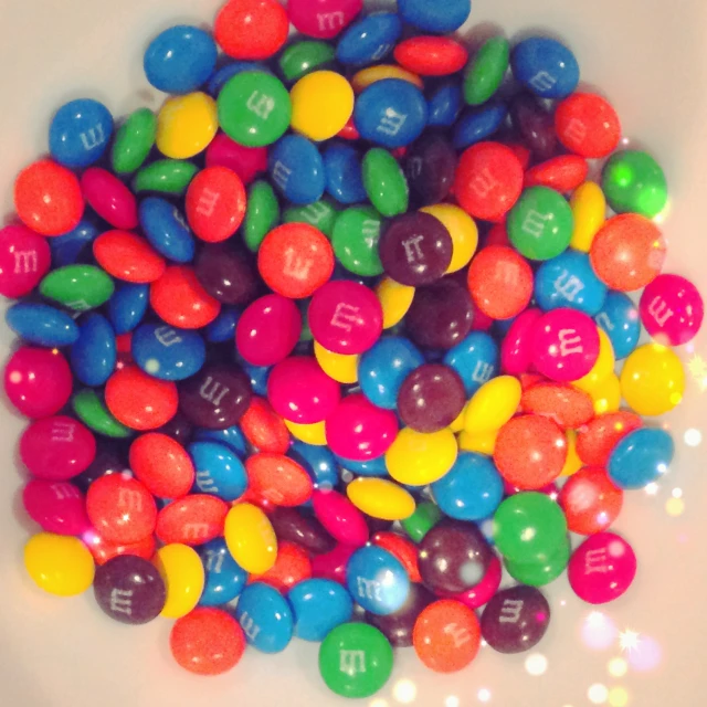 a big bowl full of colorful candy balls