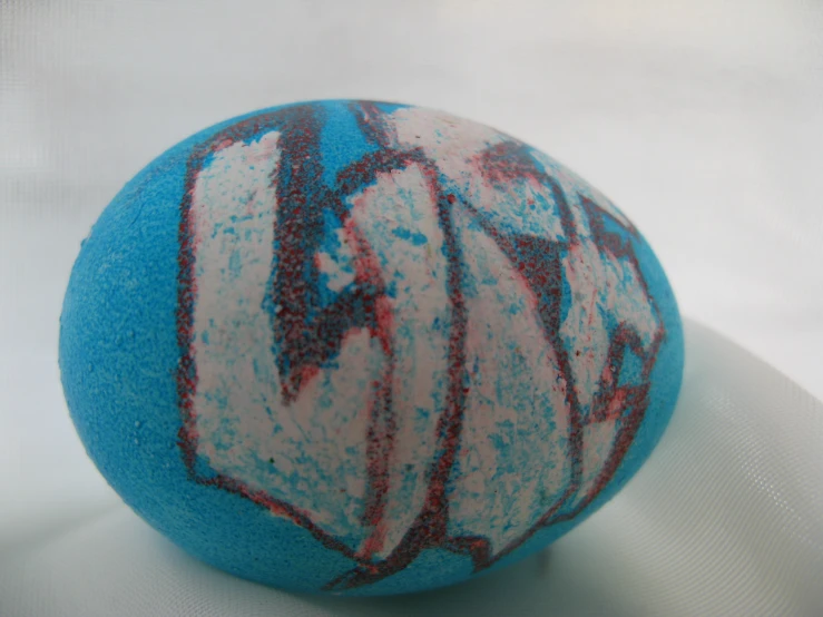a blue ball with a red and white swirl