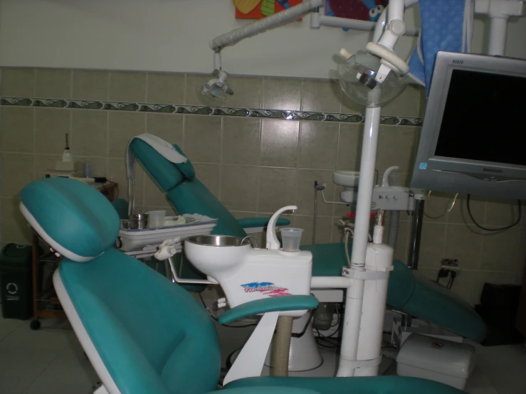 a room with a tv and a dentist's chair