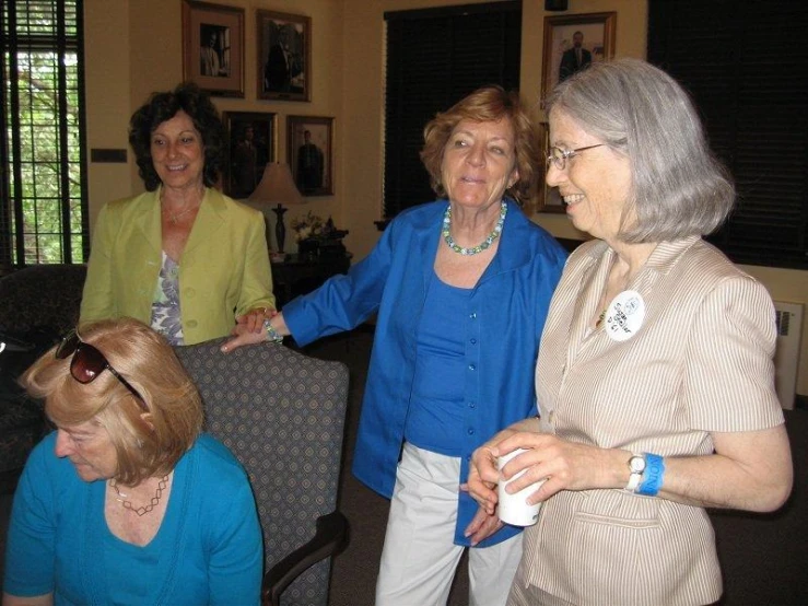 three women standing and laughing at each other