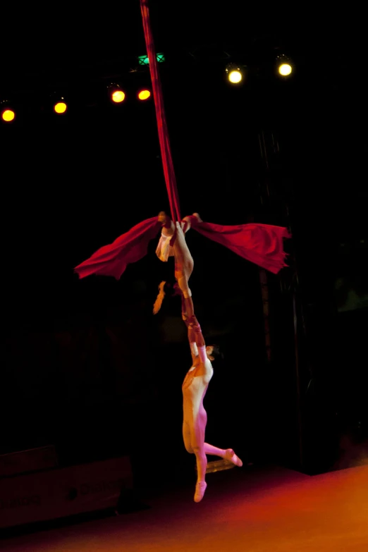 two acrobatic performers with flags on their legs