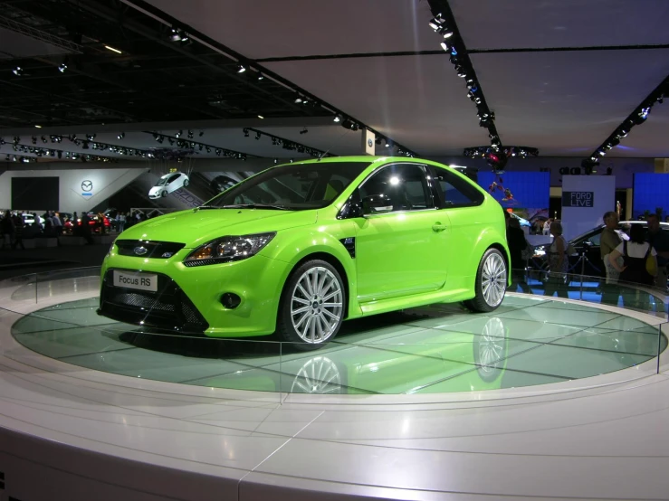 bright green car on display at an auto show